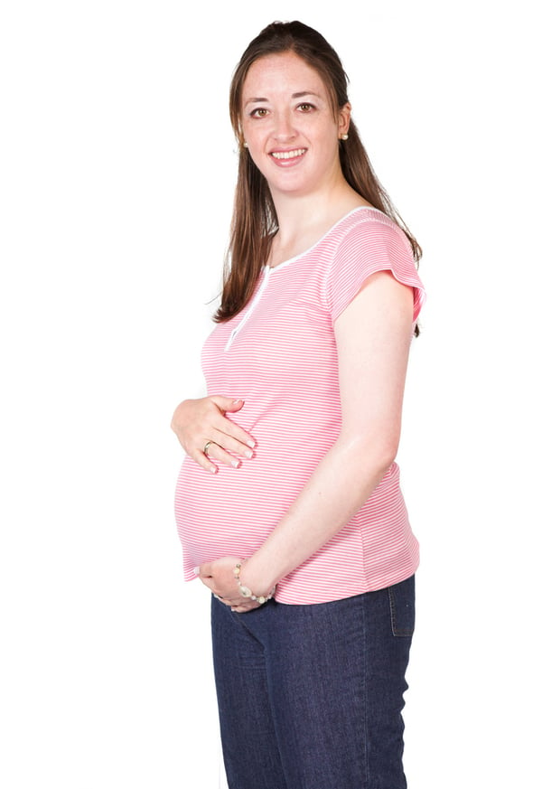 beautiful pregnant woman in pink over white