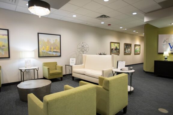 Voyage Healthcare waiting area with comfortable seating, artwork, and soft lighting, providing a welcoming environment for patients.